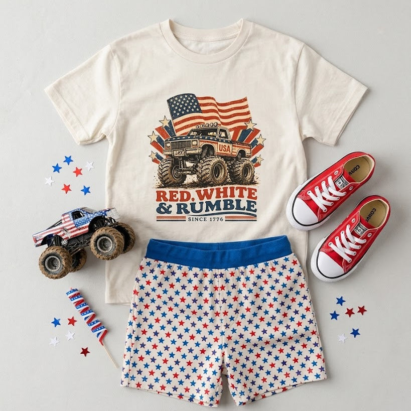 Children's outfit with t-shirt, shorts, and shoes featuring American flag and monster truck design on a gray background.