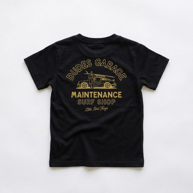Black t-shirt with gold text and graphic on a white background