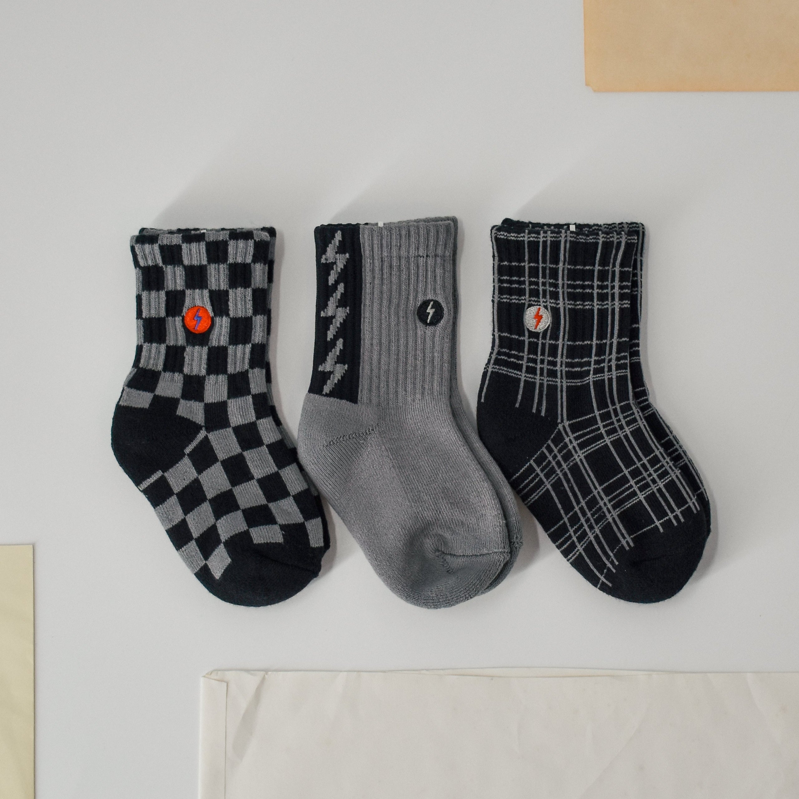 Premium kids socks with LRT spark logo on ankle, displayed to show buttery-soft cotton blend and vintage-inspired design. Lightning bolt theme showcases electric style and cushioned comfort.