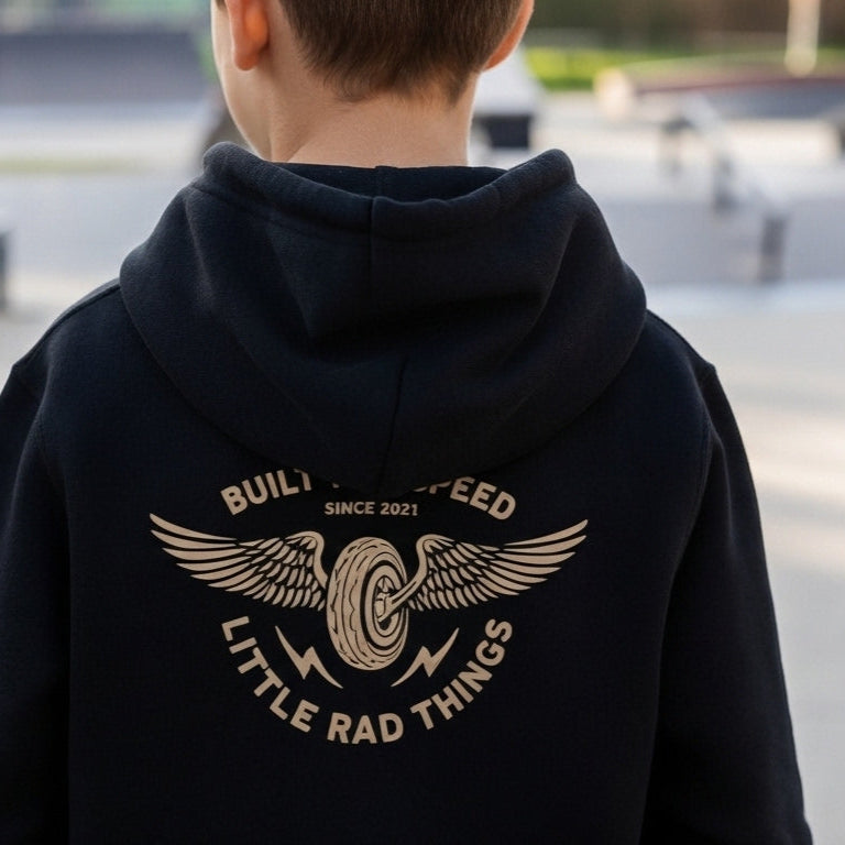Person wearing a black hoodie with a logo and text at a skate park.