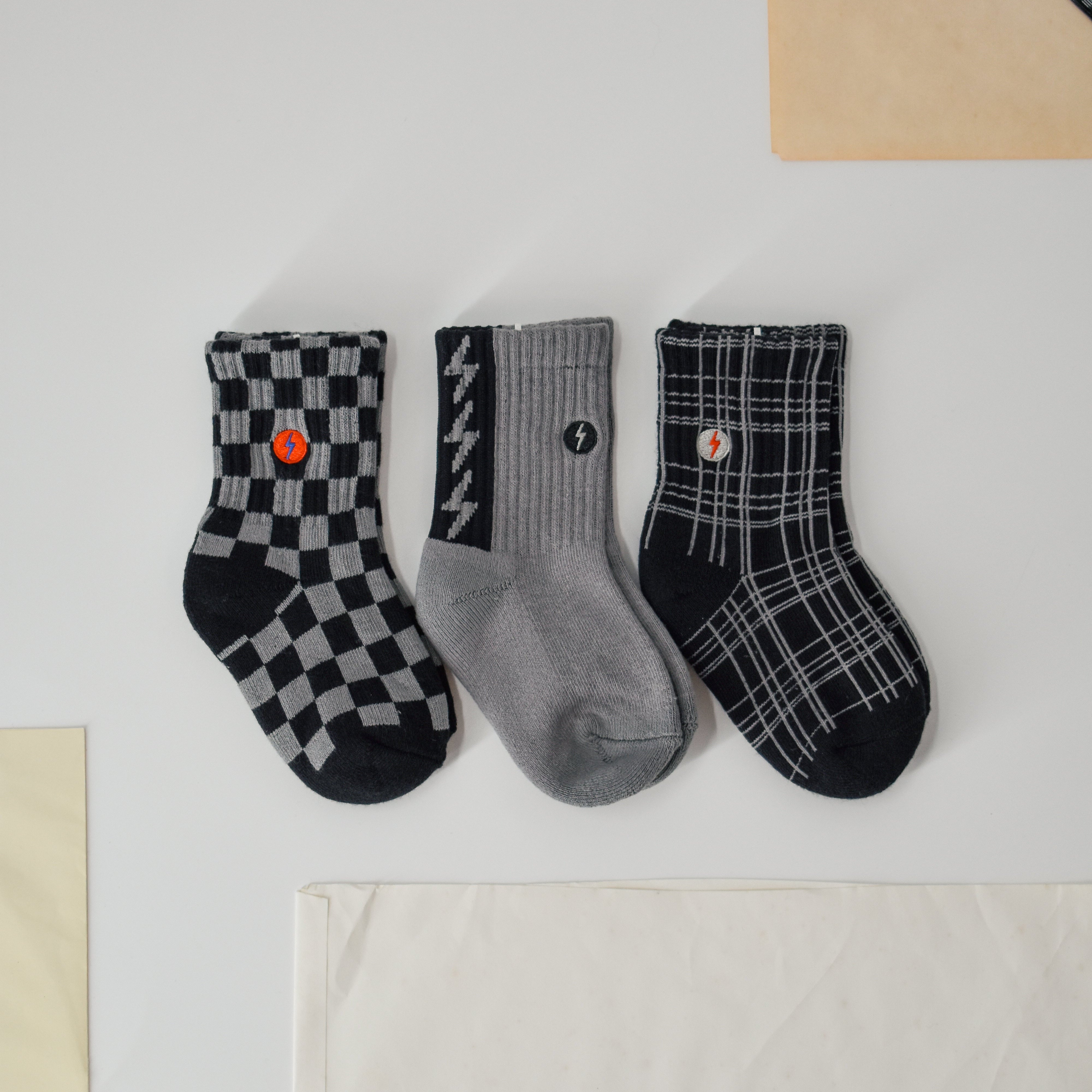 Premium kids socks with LRT spark logo on ankle, displayed to show buttery-soft cotton blend and vintage-inspired design. Lightning bolt theme showcases electric style and cushioned comfort.