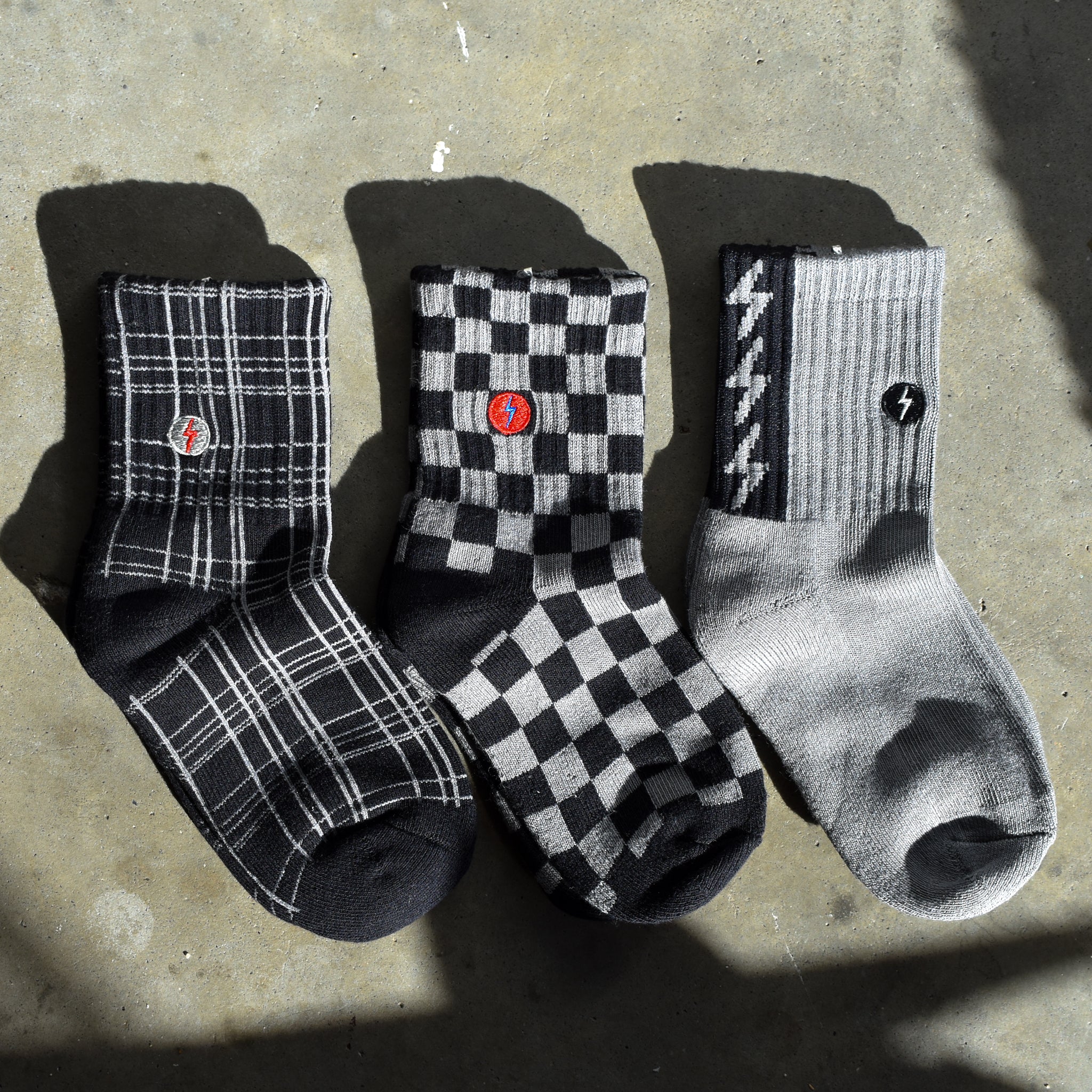 Premium kids socks with LRT spark logo on ankle, displayed to show buttery-soft cotton blend and vintage-inspired design. Lightning bolt theme showcases electric style and cushioned comfort.