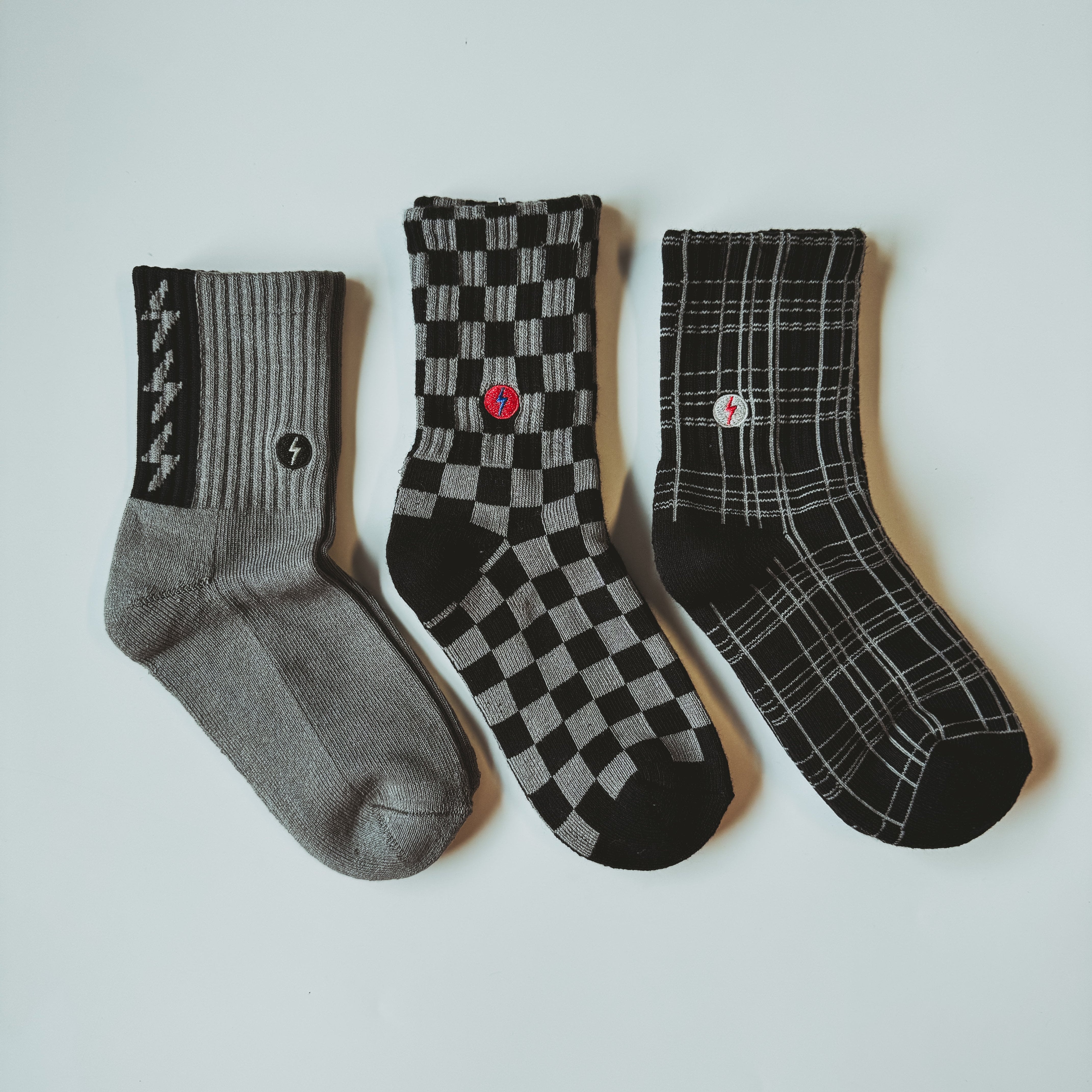 Premium kids socks with LRT spark logo on ankle, displayed to show buttery-soft cotton blend and vintage-inspired design. Lightning bolt theme showcases electric style and cushioned comfort.