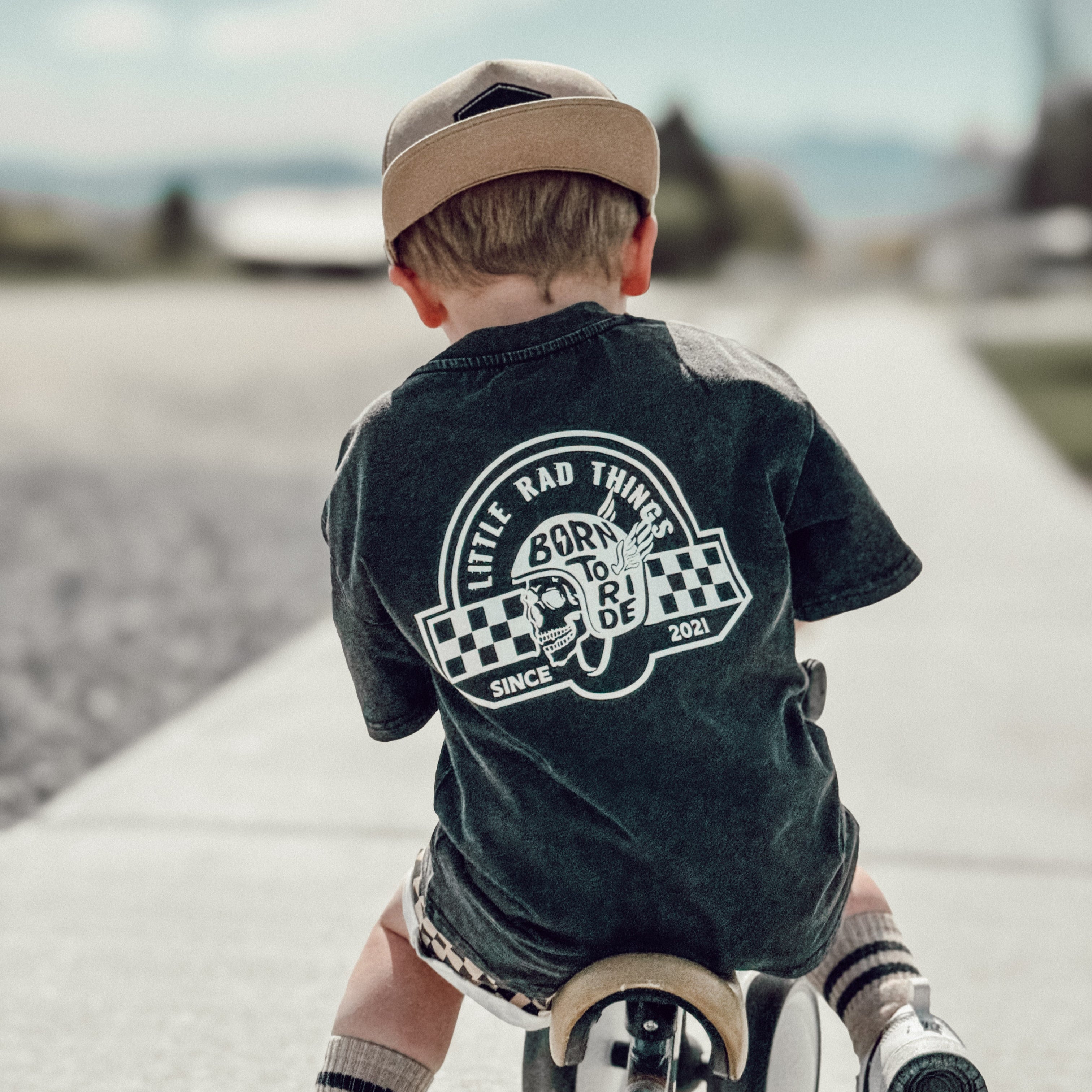 Little Rad Things toddler t-shirt featuring edgy 'Til Death Do We Ride' graphic, showcasing acid-wash texture and rebellious kid's fashion